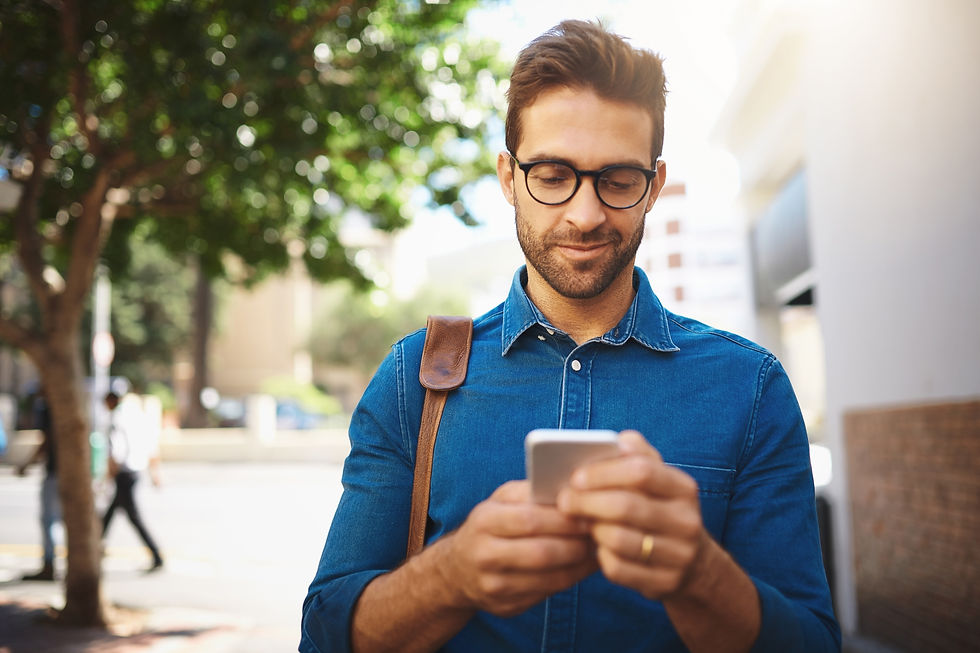 Professional man outside looking down at his mobile phone