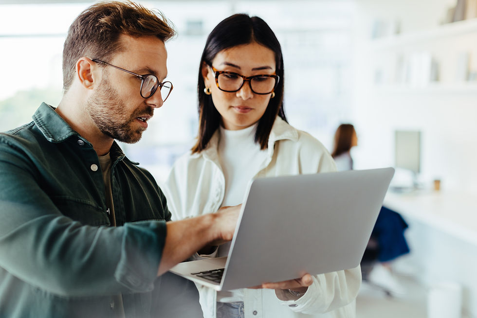 Man showing a woman something on his laptop